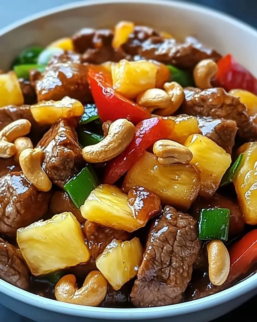 Delicious cashew beef stir-fry with pineapple served in a colorful dish