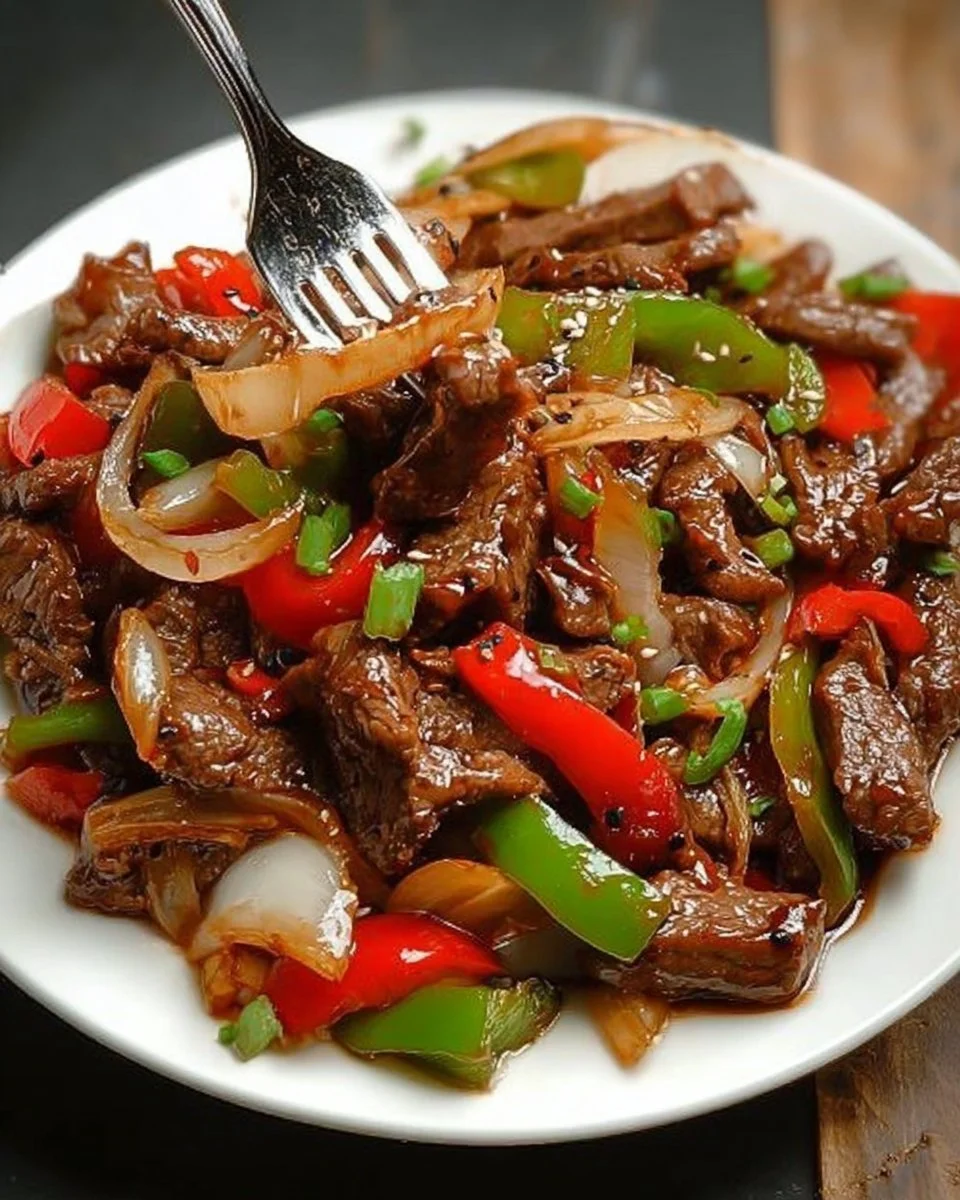 Delicious Chinese pepper steak served with colorful bell peppers and rice.